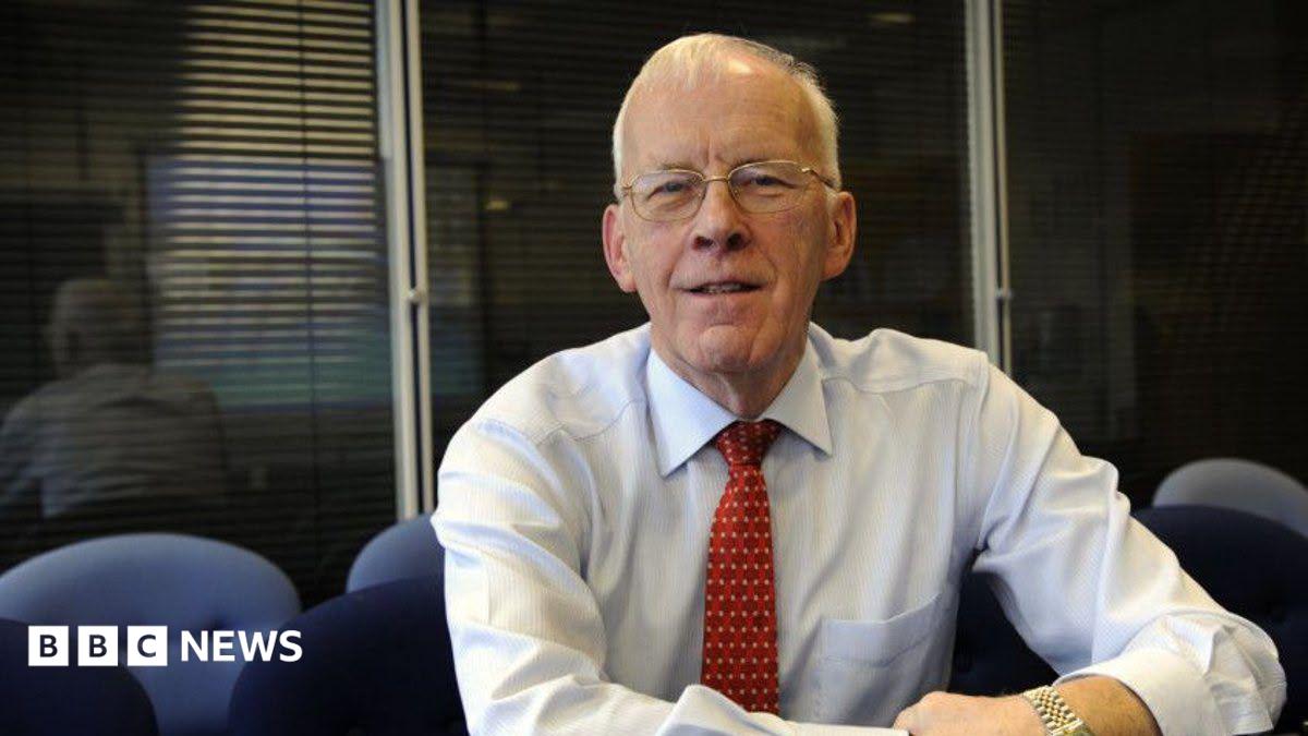 Sir Ian Wood in a shirt and tie, smiling
