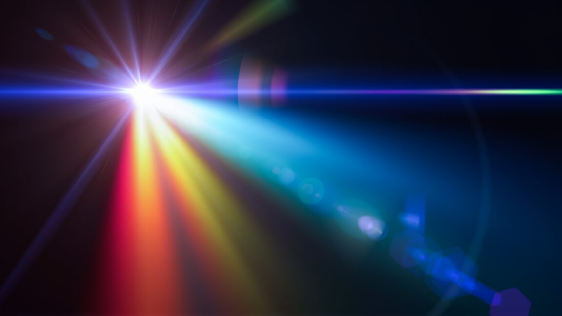 a single bright, white source of light against a black background, with lens flare and a prism effect creating a complex mix