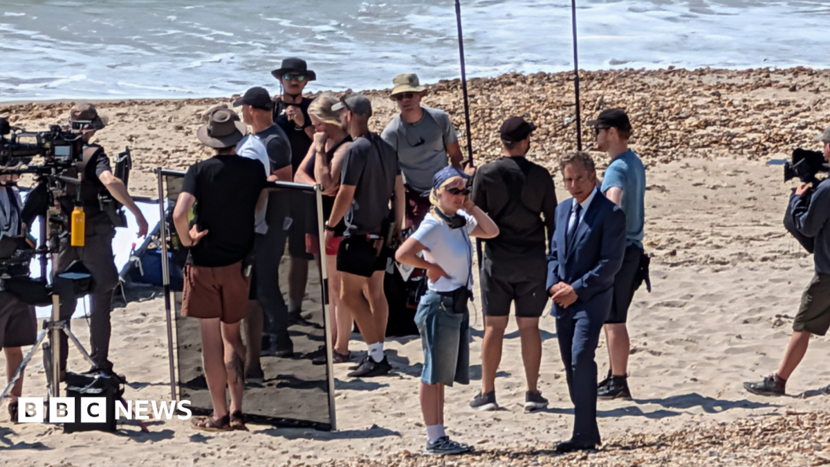 Film crews on a beach in Dorset near the sea on a sunny day