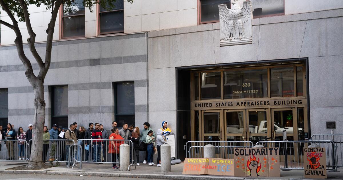 People wait outside immigration court of the US immigration and customs enforcement field office, Friday, Oct. 24, 2025, in