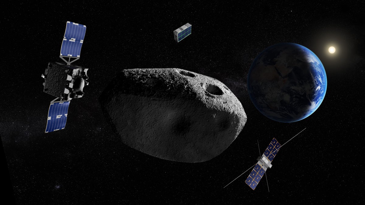 Three small robotic spacecraft approach a gray asteroid, with a crescent Earth in the background