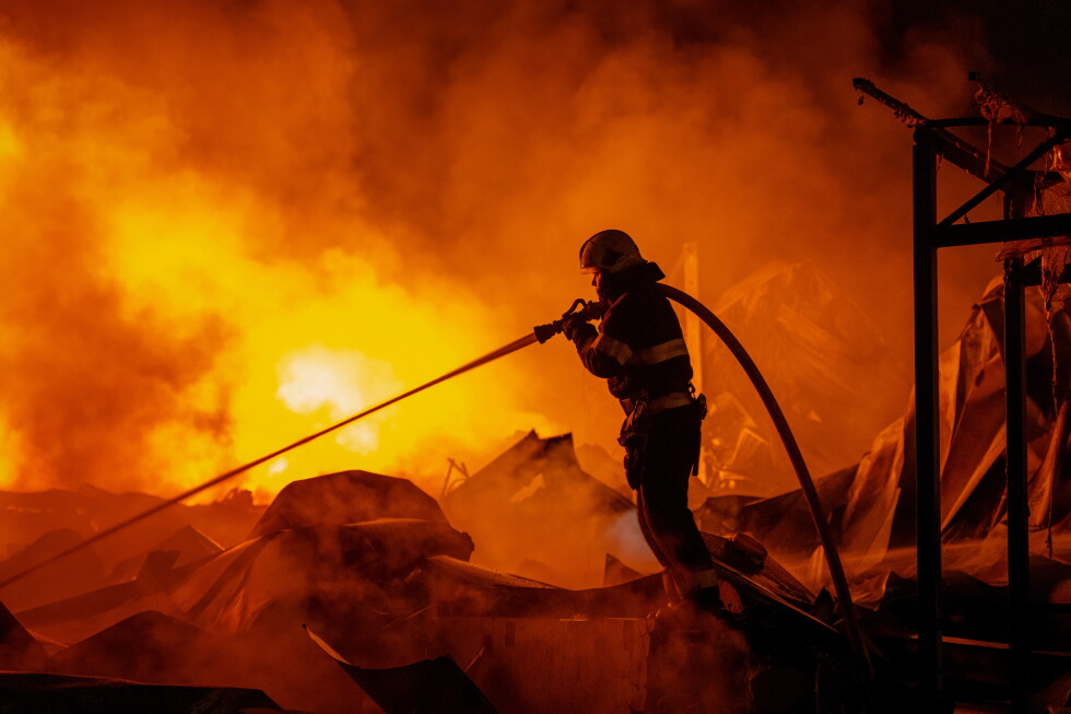 Firefighters put out a fire after Russian missiles hit a warehouse in Kyiv, Ukraine, Wednesday, Aug. 5, 2026. (AP Photo/Dan