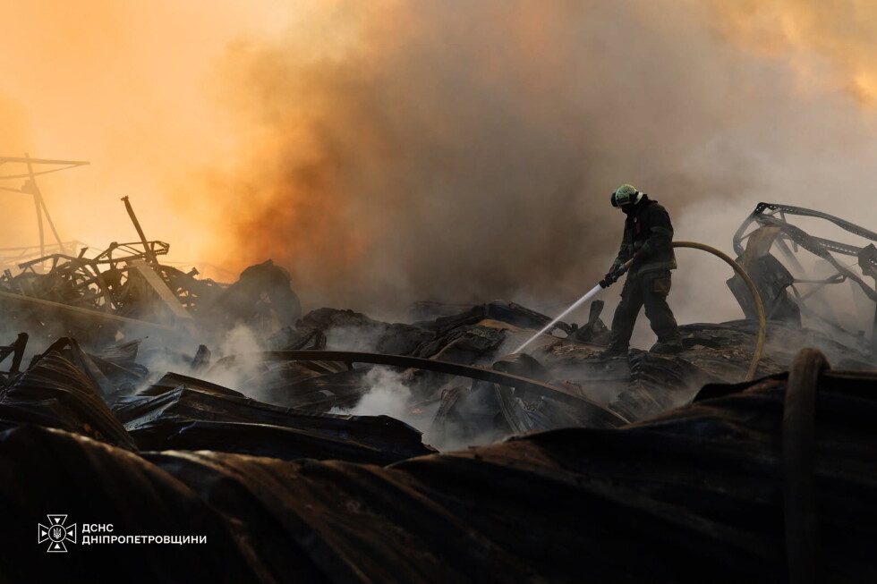 In this photo provided by the Ukrainian Emergency Service, a firefighter puts out a fire following a Russian missile attack
