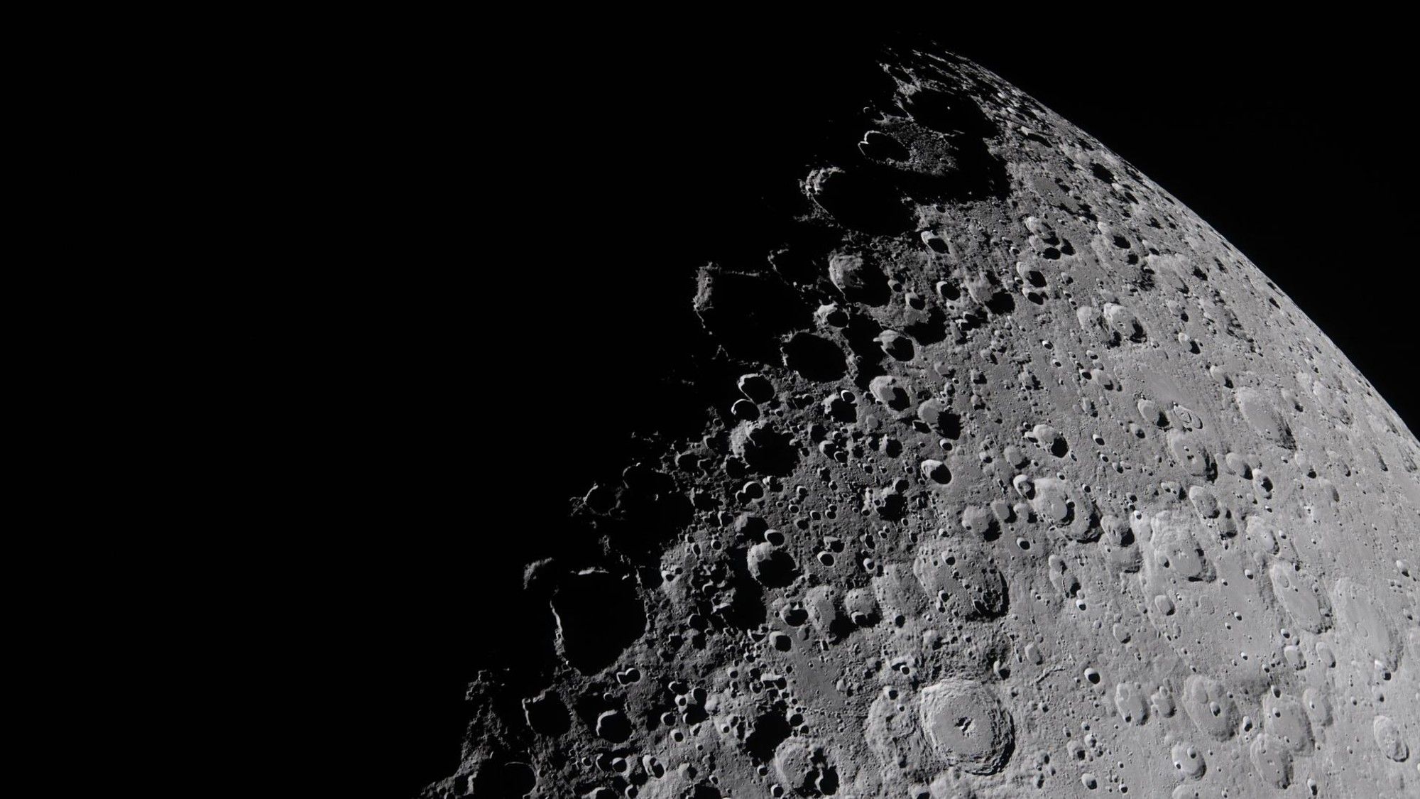 the cratered surface of the moon on a black background
