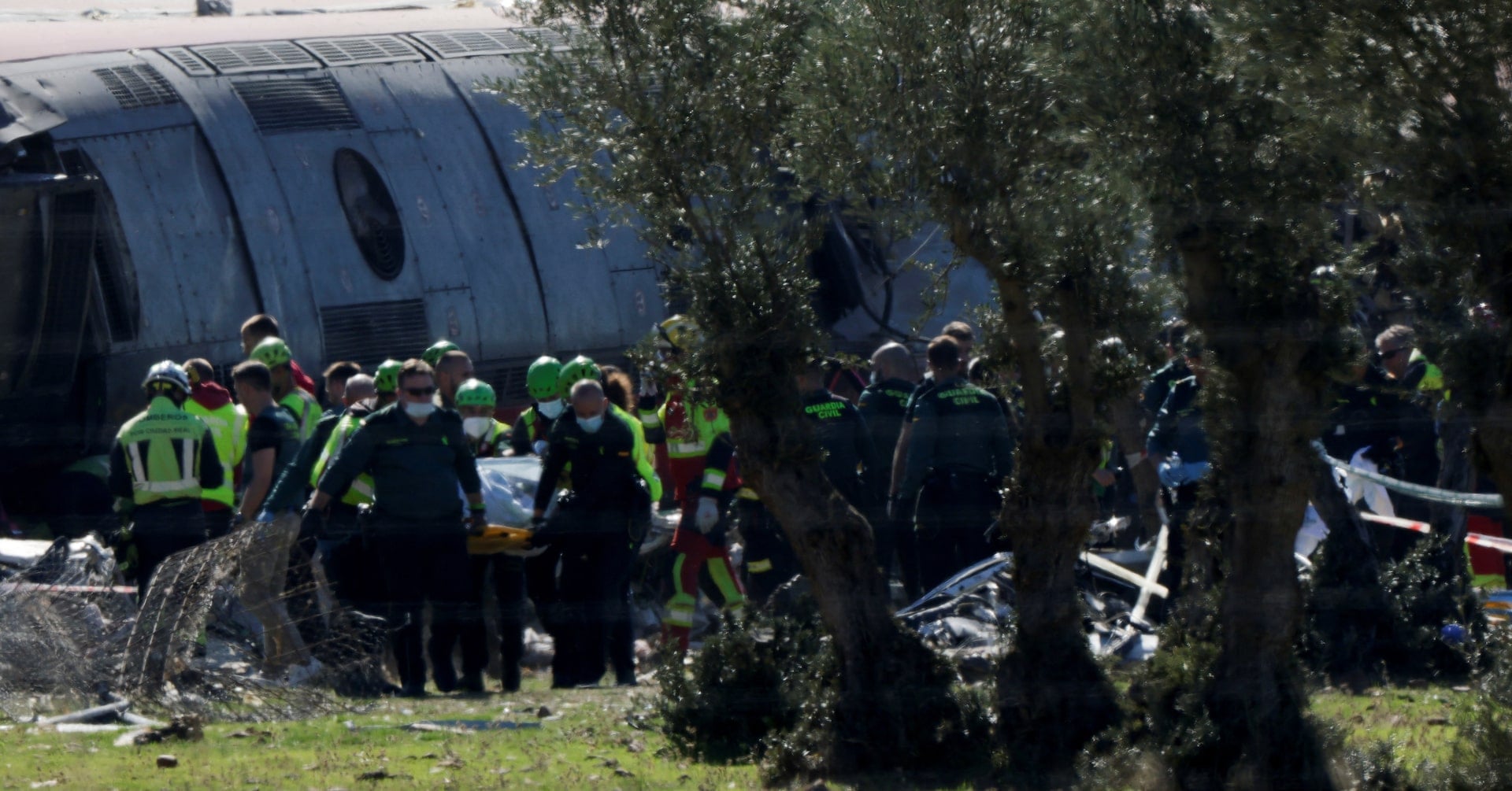 Rescue teams work at the site following the collision of two high-speed trains between the towns of Mora and Orgaz, near